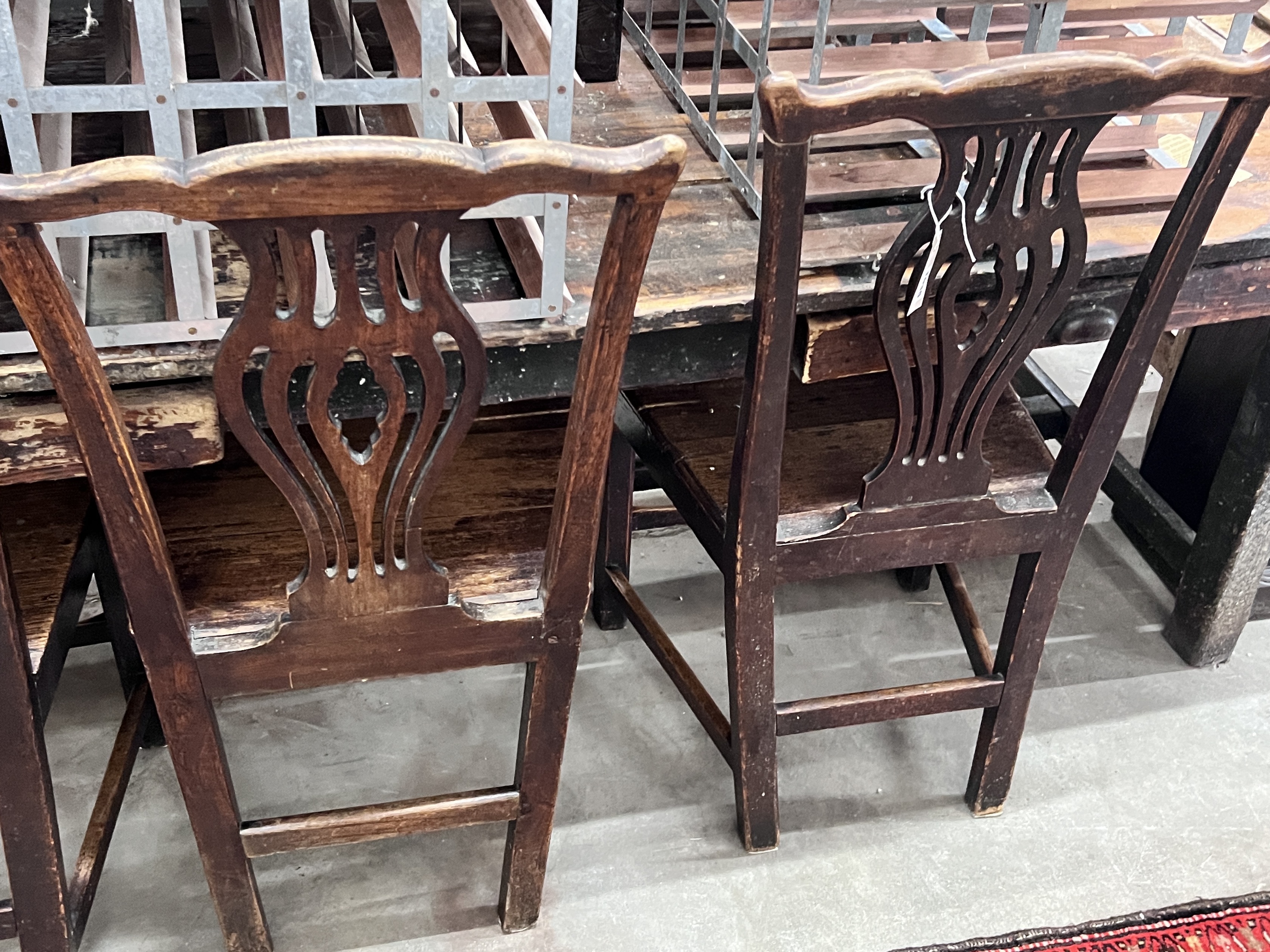 A set of four George III provincial fruitwood and oak wood seat dining chairs, width 49cm, depth 39cm, height 94cm